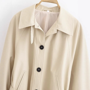 Short khaki trench coat for women with classic lapels and contrasting black buttons