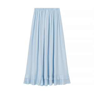Close-up of light blue maxi skirt detailing elastic waist and layered ruffle hemline