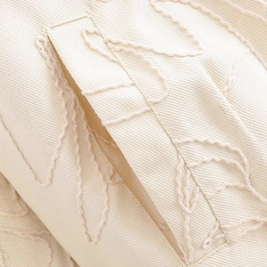 Chic cream-colored jacket with heavy leaf embroidery and detailed slanted pocket design