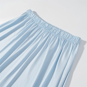 Detail view of light blue elastic waistband with soft pleats on stylish summer skirt