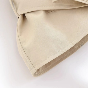 Short khaki trench coat for women showing detailed twill fabric texture and stitching
