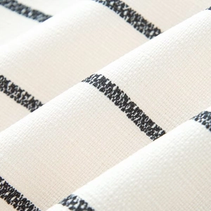 Close-up of knit fabric showing thick woven texture and black horizontal stripes