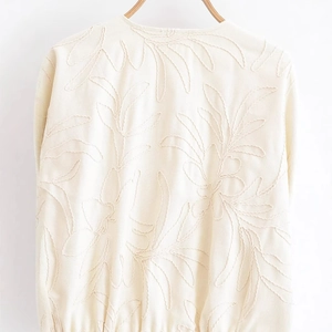 Women's off-white jacket with large embroidered leaf patterns and textured rope stitching
