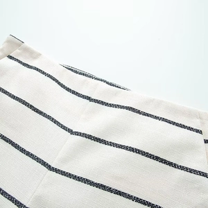 Detailed macro view of the navy horizontal stripes on off-white textured knit fabric