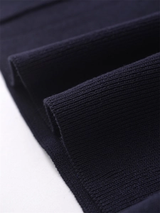 Macro detail of navy blue knit fabric showing soft texture and ribbed pattern