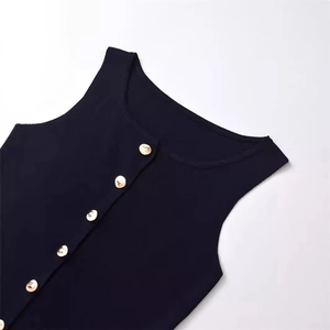 Detail of ribbed knit fabric and gold buttons on a minimalist sleeveless vest top