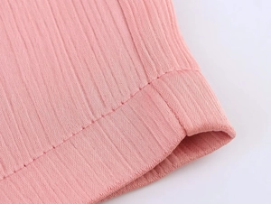Macro view of pink ribbed knit fabric detail and precise stitching on the hemline