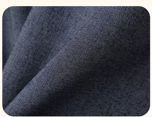 Close-up of deep blue denim fabric texture with detailed diagonal twill weaving