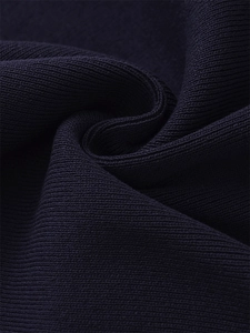Macro shot of deep navy rib-knit sweater fabric showing detailed vertical texture