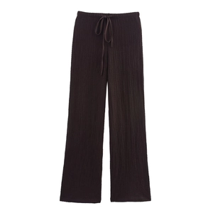 Detail of dark pleated high-waisted wide leg trousers with drawstring waist