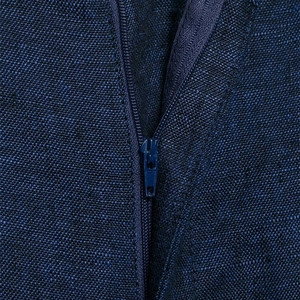 Detail view of the hidden zipper on dark blue vest suit with textured fabric finish
