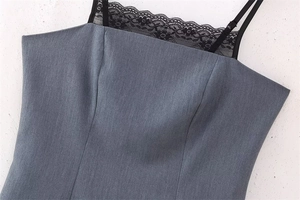 Detail of grey dress showing black floral lace trim and delicate thin shoulder straps