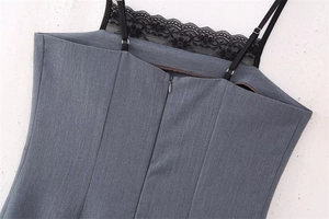 Detail of grey striped bodycon dress featuring thin black straps and lace trim at the back