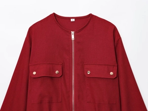 Close-up of red canvas jacket with metal zipper, flap pockets, and size S label detail