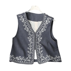 Retro V-neck denim vest for women with white floral embroidery and sleeveless open front design