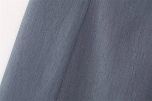 Detailed macro shot of dark grey pinstripe fabric texture with premium woven finish
