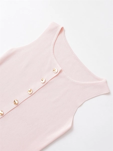 Close-up of pink knit vest showing vertical ribbed texture and gold buttons detail