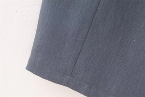 Detailed close-up showing charcoal grey pinstripe fabric texture and professional stitching