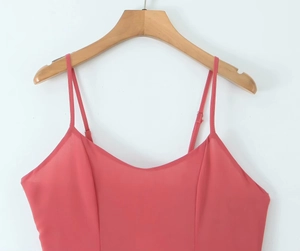 Detail view of pink sleeveless camisole dress with thin straps and structural stitching