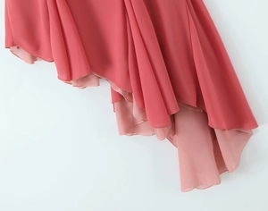 Detail of coral pink ruffled chiffon fabric with layered flowing textures for women