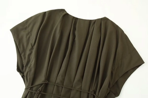 Detail of dark olive pleated back design and waist tie on this elegant summer dress
