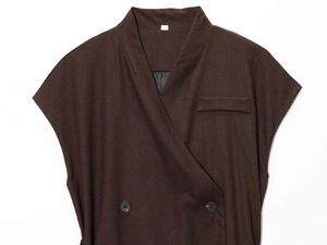 Detail of chocolate brown wrap-style vest featuring linen texture and double-breasted buttons