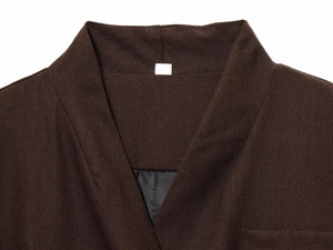 Detailed close-up of dark brown V-neckline featuring textured cotton linen fabric and lining
