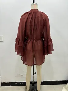 Close-up of dark red sheer chiffon blouse with layered ruffle cuffs and tie-waist detail