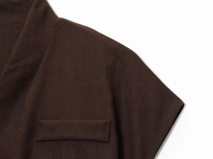 Macro shot of dark brown linen fabric texture and neck detail of double-breasted suit