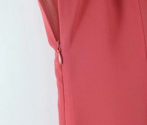 Detail view of coral red dress featuring a seamless high-quality invisible zipper closure