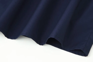 Close-up of navy blue fabric hem with high-quality stitching on minimalist shirt