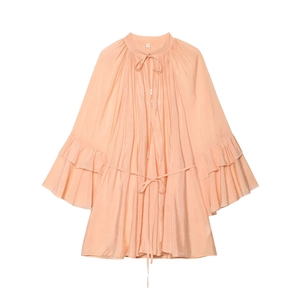 Detail of ruffled sleeves and pleated collar on apricot chiffon dress with tie neck