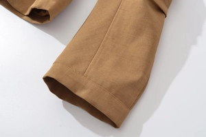 Close-up of tan twill cotton fabric with durable double-stitch hem details
