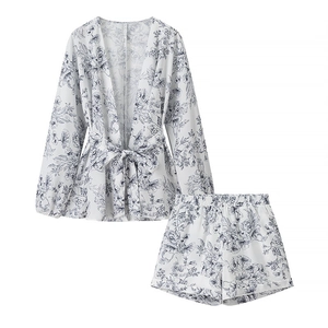 Flat lay detail of two-piece kimono pajama set with gray-blue botanical floral print
