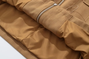 Detailed close-up of camel jacket twill fabric texture with metal zipper and smooth lining