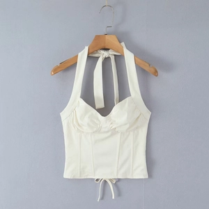 Close-up of white halter corset top with pleated bust details and drawstring hemline