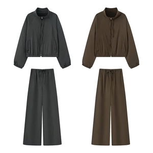 Close-up of long sleeve zip-up hoodie and wide-leg pants set in dark grey and brown
