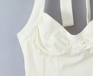 Detail of white corset crop top with heart neckline, ruched cups and structured boning