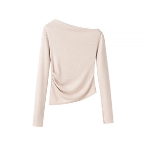 Close-up of asymmetrical off-shoulder neckline and drawstring ruching detail on beige knit top