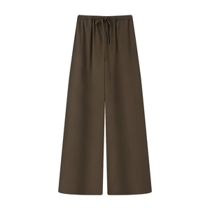 Detail of deep brown wide-leg pants with elastic drawstring waist and premium drape
