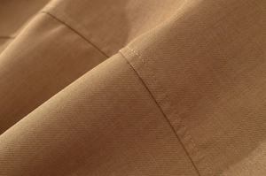 Macro shot of durable khaki plain weave fabric with precision single-needle stitching