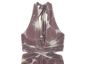 Detail of floral print halter dress featuring criss-cross waist and side cut-outs