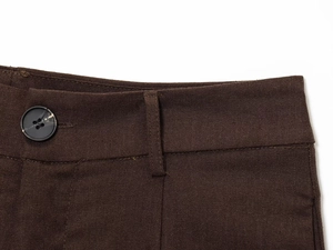 Detail of deep brown high-waist pants with black button and belt loops in twill fabric