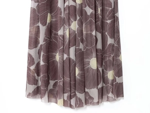 Detail of sheer purple floral print on light mesh fabric with elegant pleated texture