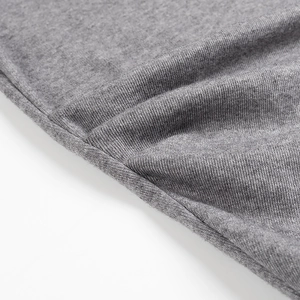 Detailed close-up of the grey knit fabric texture and soft ribbed stitching pattern