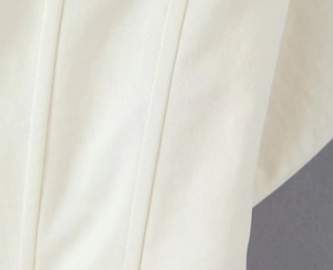 Detailed macro view of white twill fabric with professional double needle stitching