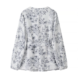 Elegant floral print long sleeve blouse for women with tie-back waist design on white backdrop