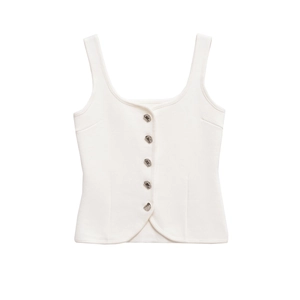 Detailed close-up of white knitted vest with square neck and unique silver metal buttons