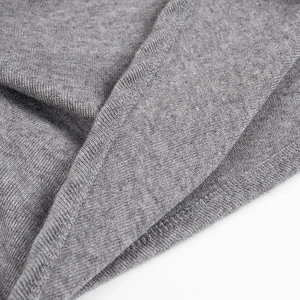 Macro shot of grey knit fabric texture featuring high-quality overlock stitching details