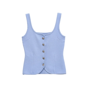 Detail showing honeycomb textured light blue knit vest with vintage metallic buttons
